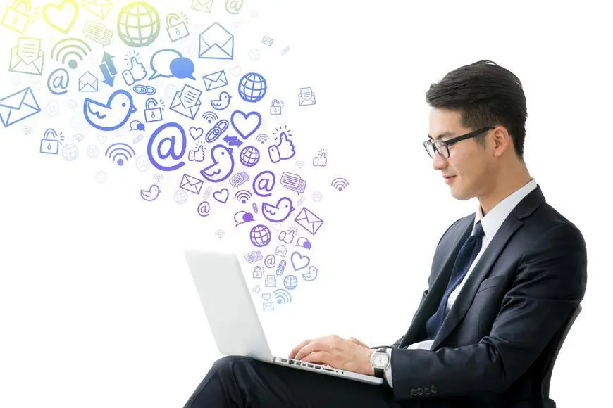 Man at laptop with social media icons for SEO and design